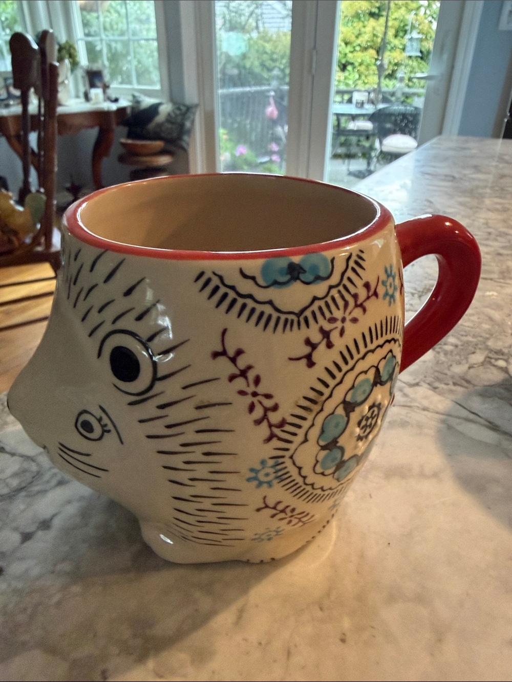 Decorative White Ceramic Animal Face Mug with Red Handle and Blue Floral Accents